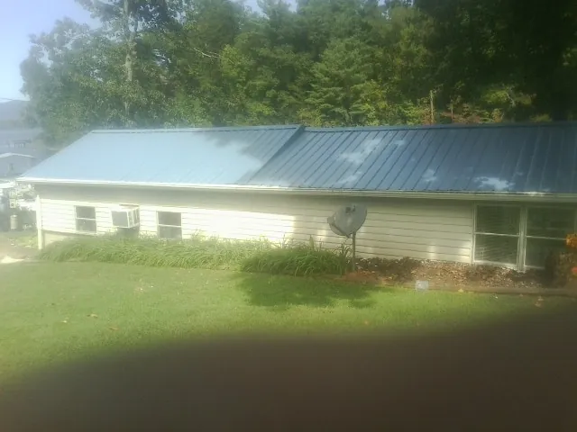 Blue metal roof running the length of a single story home in Pinehurst